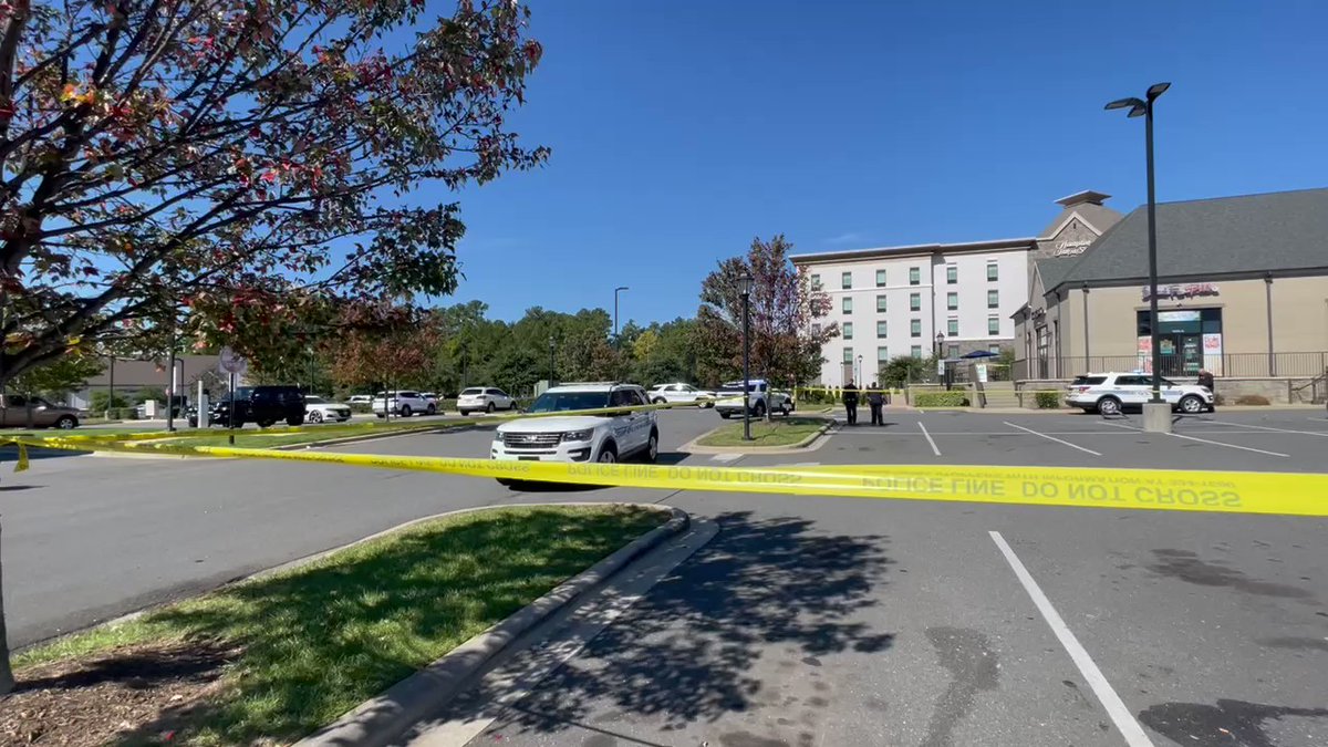 Medic confirms one person has been taken to the hospital with  life-threatening injuries after a shooting in this busy Harris Teeter parking lot. A damaged blue-grayish Chevy Tahoe appears to also be a focus point in this investigation. 