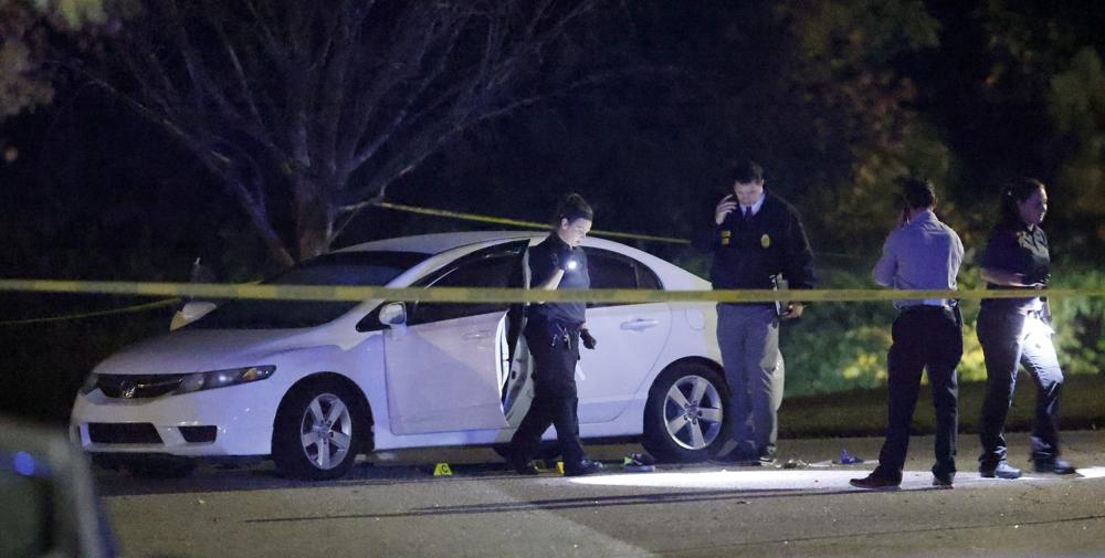 Police work a shooting scene on Osprey Cove Drive in the Hedingham neighborhood in Raleigh, N.C.,